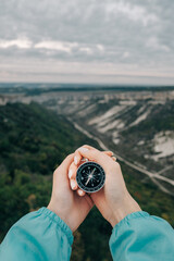 Sticker - Compass in female hands. Exploration and adventure concept. In the background is a canyon