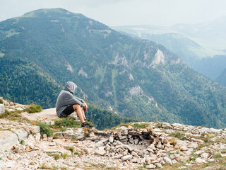 Man relax in the mountains on nature beautiful landscape fresh air fog sunlight