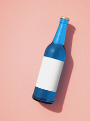 Leinwandbilder - Single blue glass beer bottle laying on pink surface.