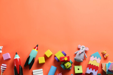 Wall Mural - Different toys on orange background, flat lay. Space for text