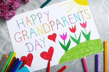 Wall Mural - Beautiful drawing on grey marble table, flat lay. Happy Grandparents Day