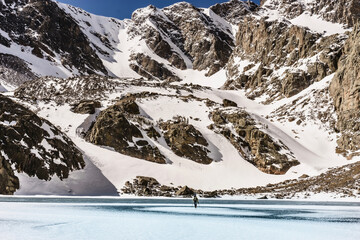 Wall Mural - snowboarder hiking in the mountains