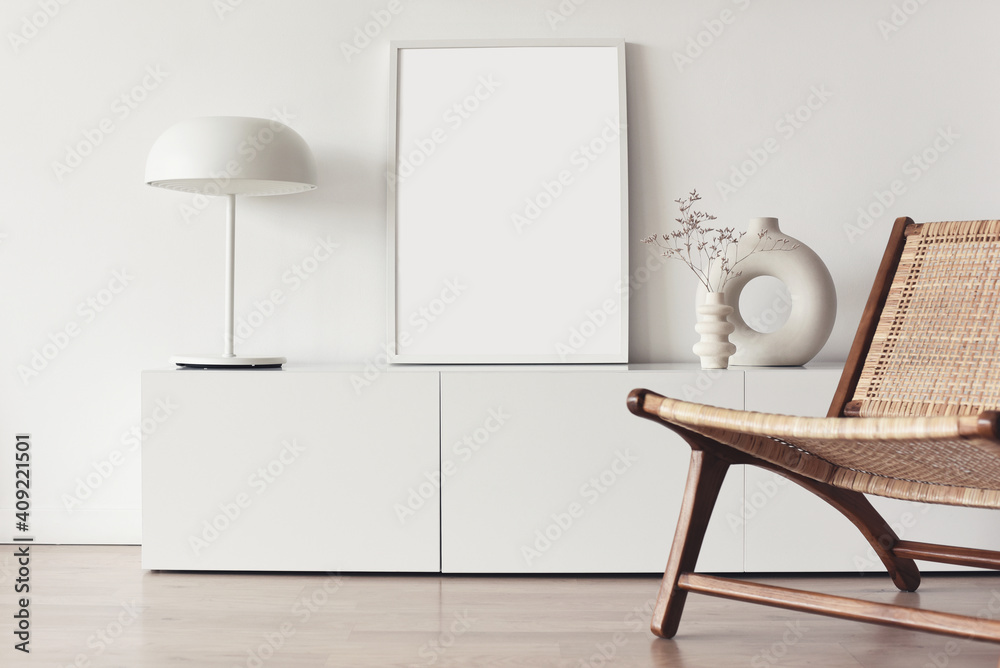 Blank picture frame mockup on white wall. White living room design. View of modern scandinavian style interior with chair. Home staging and minimalism concept - obrazy, fototapety, plakaty 