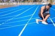 © Tom Wang - young man suffering from sudden ankle and leg pain during the workout at the stadium