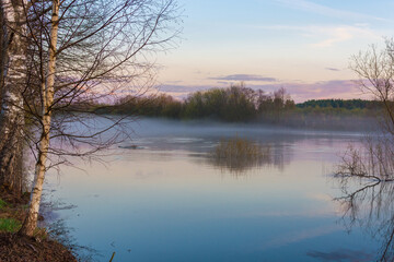  Spring nature. The river flooded, spring flood. Fog over the water. Horizontal photo.