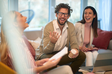 A group of young business people at a meeting laughing at jokes in a break of work. People, business, meeting