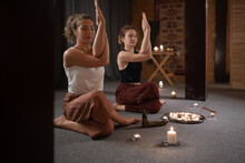 Female Friends Meditating With Eagle Arms Together