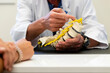 © Cavan Images - doctor shows spine to patient