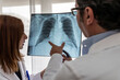 © Cavan Images - two doctors read a chest x-ray