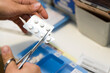 © Cavan Images - a nurse prepares a patient's pill organizer