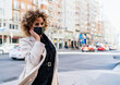 © Cavan Images - portrait of afro hair woman with mask