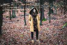 Natural Strong Woman With Winter Coat And Scarf Stands In Golden Woods
