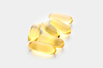 Wall Mural - Omega-3 Fish Fat Oil Capsules. Fish oil capsules isolated on white background. Close up of capsules Omega 3 on white background. Health care concept. Nutritional supplements. Vitamins