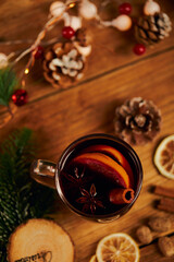 Sticker - Cup of hot tea with citrus and cinnamon on wooden table with dried lemon slices and Christmas decors