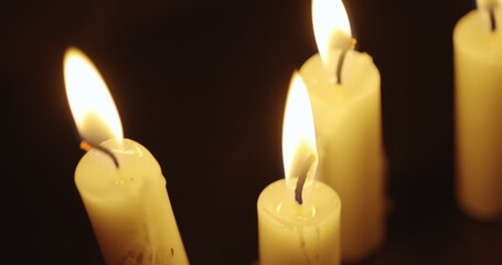 Wall Mural - Candles glowing against dark background