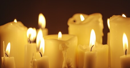 Wall Mural - Candles glowing against dark background