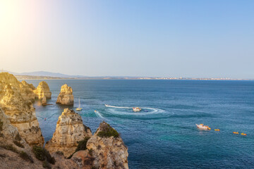 Wall Mural - Panoramic perspective into the ocean from the rocky cliffs of Ponta da Piedade in Lagos, Portugal. Sunny day