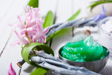 Canvas Print - cosmetic cream product samples with hyacinth flowers on white wooden background