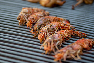 Wall Mural - BBQ grilled prawns and llangoustines. Street food