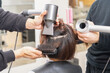 © garage38 - ヘアサロンでドライヤーを使って髪の毛を乾かす美容師の手元
