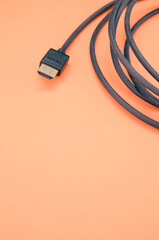 Canvas Print - Closeup shot of HDMI cable isolated on a coral background