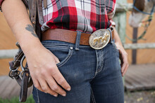 Close Up Young Cowgirl With Belt Buckle And Tattoo