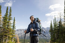 Male Backpacker Hiking In Sunny Rocky Mountains, Canada