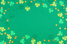 St Patricks Day Green Background With Shamrock And Gold Coin Confetti Frame. Above View With Copy Space.