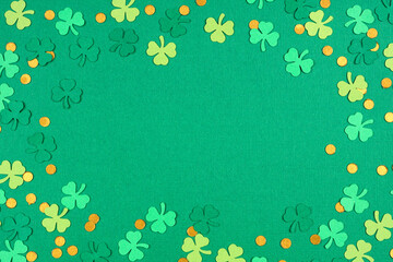 Poster - St Patricks Day green background with shamrock and gold coin confetti frame. Above view with copy space.
