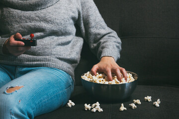 Playing video games and eating popcorn on the couch at home