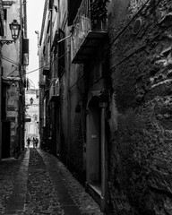 Wall Mural - Black and white image of a narrow alley in Tropea historic center, Calabria, Italy