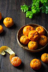 Jeruk Santang or Mandarin orange on wooden dark background. 
