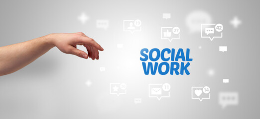Aufkleber - Close-Up of cropped hand pointing at SOCIAL WORK inscription, social networking concept