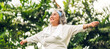 © Art_Photo - Portrait of happy senior old adult elderly asia women smiling standing and stretch her arms relax and enjoy with nature feeling breath fresh clean air in green park.Healthcare