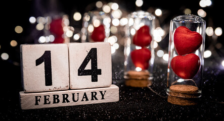 Wall Mural - Two Red Hearts in Cork Glass Bottles With Calendar showing 14 february Background for Valentine's Day