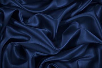 Wall Mural - Dark blue silk satin fabric. Elegant fabric background. Liquid wave or silk soft wavy folds. Beautiful navy blue color abstract background with copy space for your design.