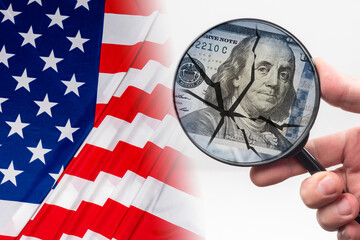 Crisis intervention in US economy. Concept - search for destruction in American economy. Hand with a magnifying glass in front of dollars. Crack as a symbol of US federal economy  destruction.