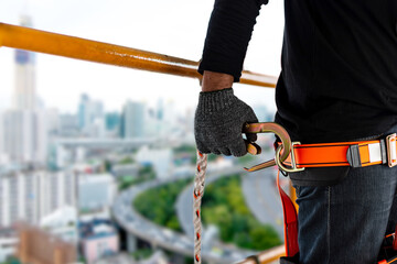 Construction worker wearing safety harness and safety line