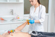 © salomonus_ - Cardiogram of the heart. Cardiologist attaches electrodes of an electrocardiograph to a young man. Cardiology