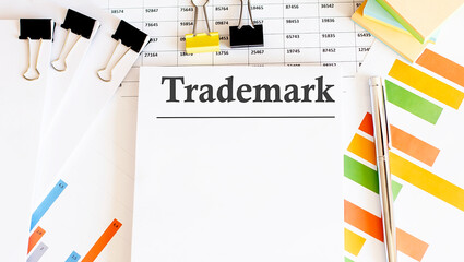 Poster - Paper with text TRADEMARK on a table