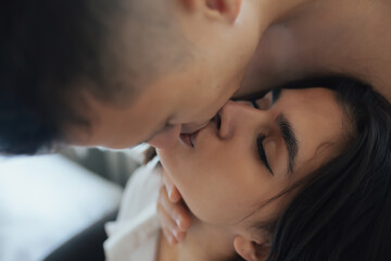 Wall Mural - Close-up of couple in love kissing passionately with closed eyes. Cropped shot.