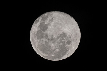 Wall Mural - Full moon stack dark night sky. The full moon is lunar phase when It appears fully illuminated from Earth's perspective. It occurs when Earth is located between Sun and Moon appears as a circular disk