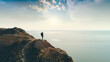 © realstock1 - The hiker standing on a mountain on the sea sunshine background