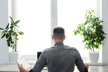 Smiling young man freelancer using laptop, studying online, working from home, happy casual guy typing on pc notebook surfing internet, enjoying distant job, sit at table.