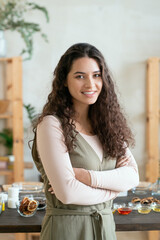 Wall Mural - Girl standing by table with ingredients for making natural cosmetic products