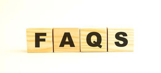 The word FAQS. Wooden cubes with letters isolated on white background.