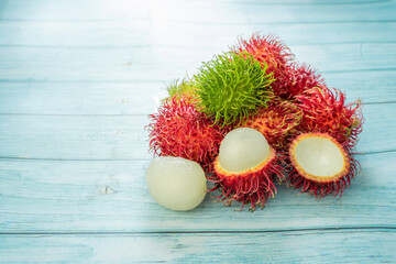 Wall Mural - Rambutan from an orchard on an old blue table, slective focus