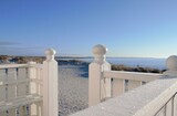 Fototapeta  - Detail of a white fence on the beach