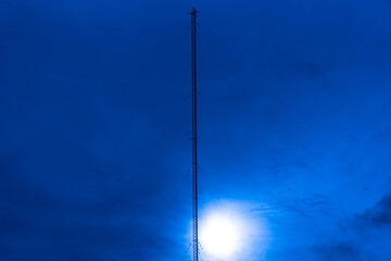 Wall Mural - Radio Frequency Modulated Wave Transmission Tower - FM in contrast with the sunset