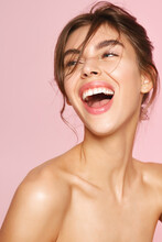 Beauty And Skincare. Happy Caucasian Woman With Fresh Glowing, Hydrated Skin, Standing Naked Body And Smiling, Laughing And Gazing Aside, Feeling Healthy And Upbeat, Pink Background